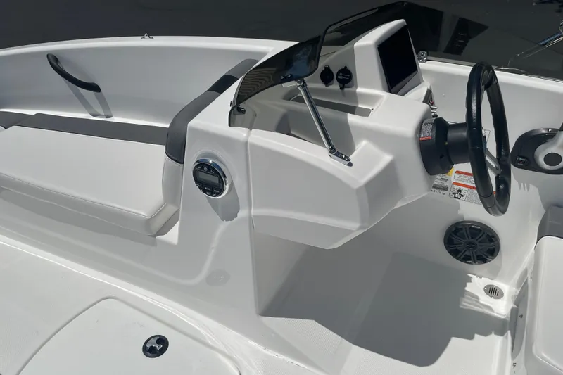 Slide: The Image of 2026 Tahoe T16 boat interior with steering wheel and dashboard controls. - 18