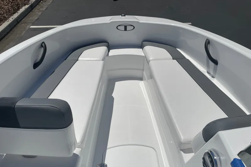 Slide: The Image of 2026 Tahoe T16 boat interior with white and gray seating, sleek design. - 16