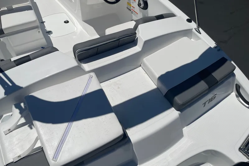 Slide: The Image of 2026 Tahoe T16 boat interior with cushioned seating and sleek design. - 23