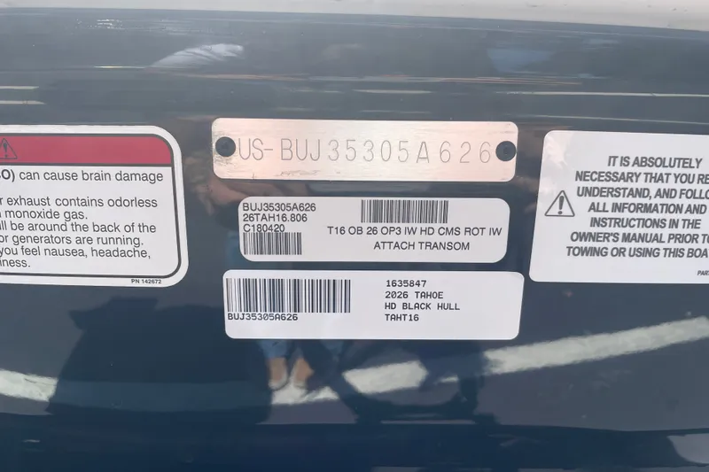 Slide: The Image of 2026 Tahoe T16 boat identification labels and safety warnings on black hull. - 81
