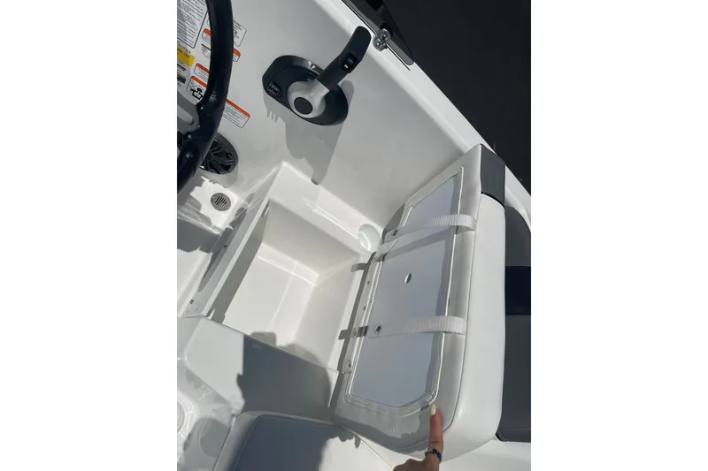 Slide: The Image of The image shows a boat interior with a white seat and storage compartment underneath. - 13