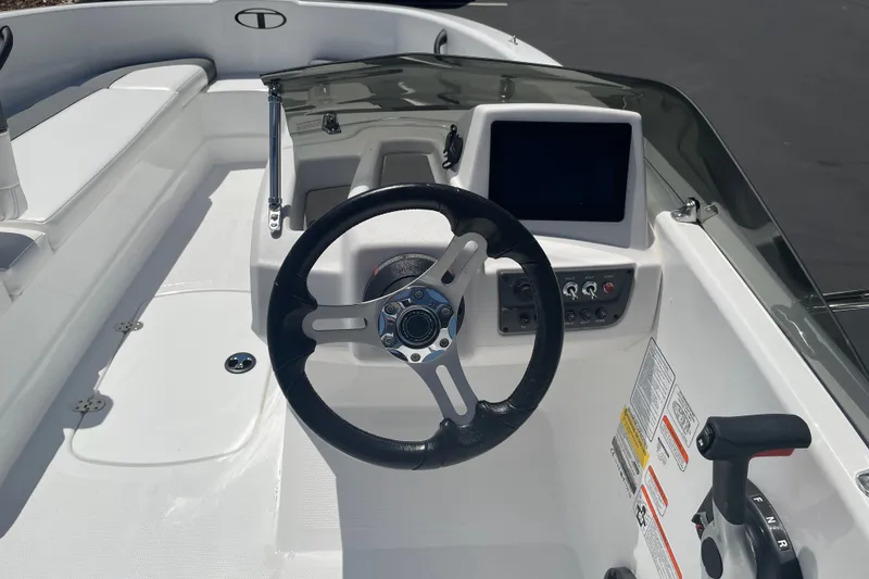 Slide: The Image of Steering console of a 2026 Tahoe T16 boat with modern controls and display. - 20