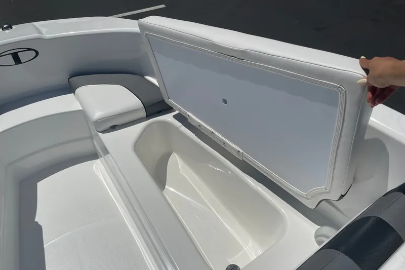Slide: The Image of 2026 Tahoe T16 boat interior with open storage compartment and cushioned seating. - 15