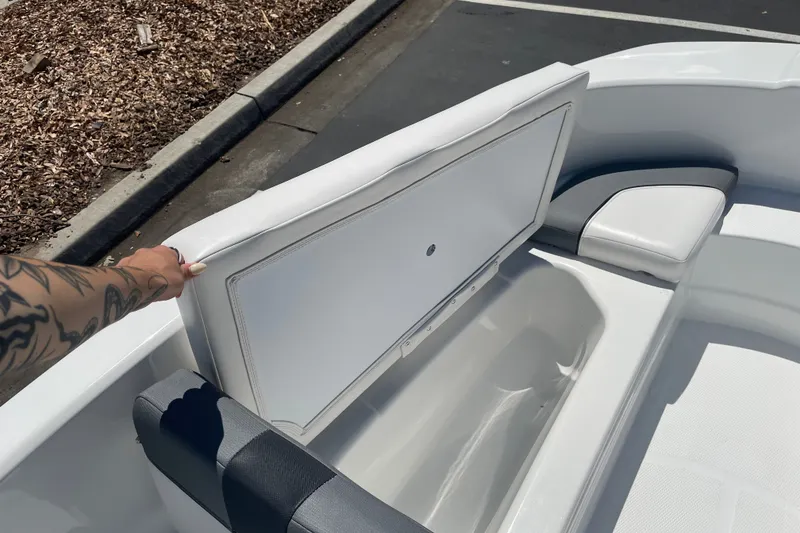 Slide: The Image of 2026 Tahoe T16 boat interior with open storage compartment and white seating. - 14