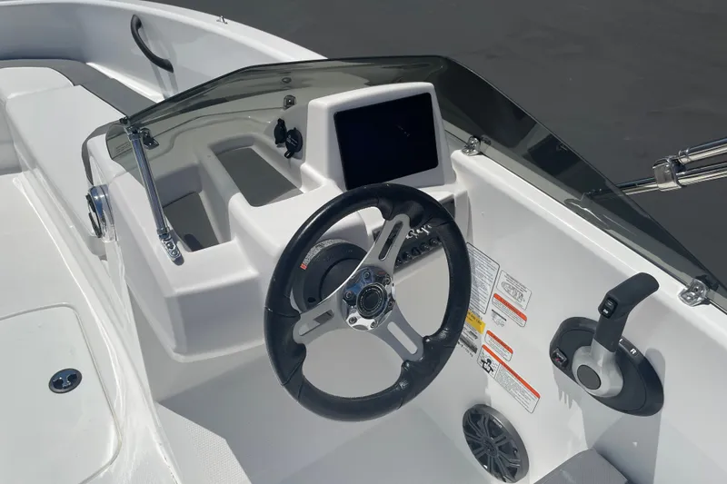 Slide: The Image of 2026 Tahoe T16 boat dashboard with steering wheel and control panel. - 19