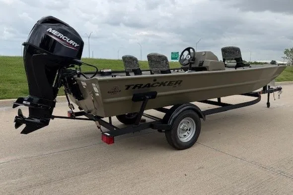 The Image of 2026 Tracker Grizzly 1754 SC boat with Mercury engine on trailer, parked outdoors. - 1