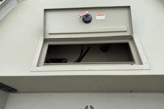 Slide: The Image of Open storage compartment on 2026 Tracker Grizzly 1754 SC boat, showcasing interior space. - 14