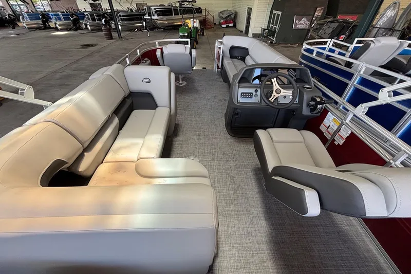 Slide: The Image of 2026 Sun Tracker SportFish 20 DLX pontoon boat interior with seating and steering console. - 4