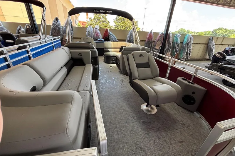 Slide: The Image of 2026 Sun Tracker SportFish 20 DLX pontoon boat interior with plush seating and modern design. - 2
