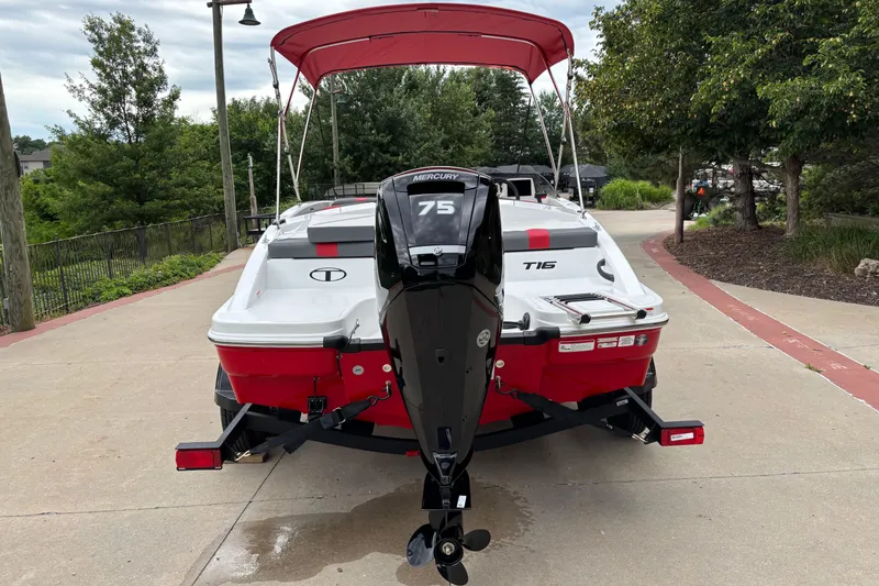 Slide: The Image of 2026 Tahoe T16 boat with Mercury 75 engine, parked on a driveway. - 1