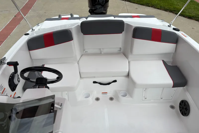 Slide: The Image of 2026 Tahoe T16 boat interior with white and gray seating, red accents, and steering wheel. - 4