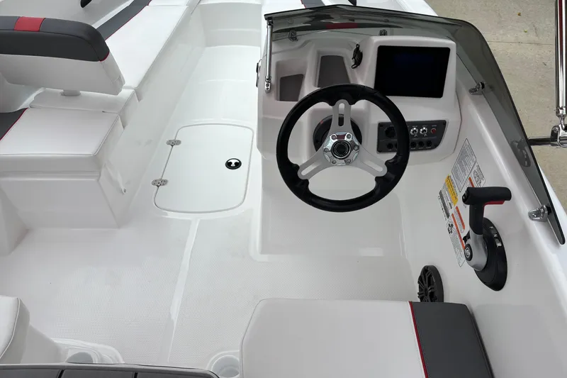Slide: The Image of 2026 Tahoe T16 boat interior with steering wheel, control panel, and seating. - 5