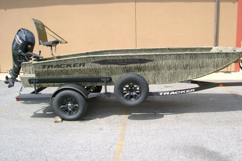 The Image of 2026 Tracker Grizzly 1650 T Prairie Wings Edition boat on trailer, camouflage design. - 0
