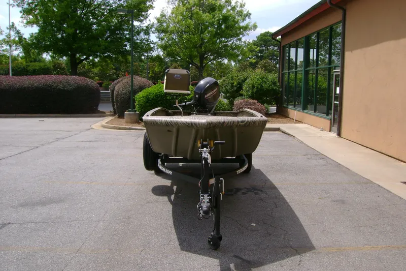 Slide: The Image of 2026 Tracker Grizzly 1650 T Prairie Wings Edition boat parked outdoors. - 3