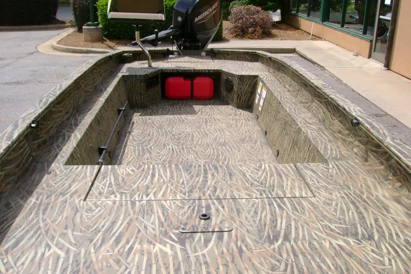 Slide: The Image of 2026 Tracker Grizzly 1650 T Prairie Wings Edition boat with camo interior and Mercury motor. - 4
