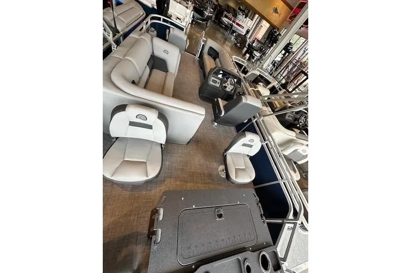 Slide: The Image of 2026 Sun Tracker SportFish 20 DLX pontoon boat interior with plush seating and modern helm. - 2