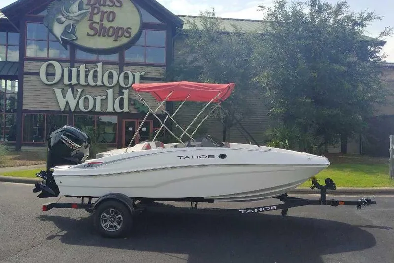 Slide: The Image of 2026 Tahoe T16 boat with red canopy outside Bass Pro Shops Outdoor World. - 0