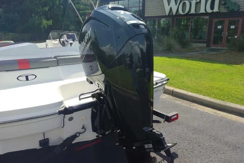 Slide: The Image of 2026 Tahoe T16 boat with Mercury outboard motor, parked near a building. - 4