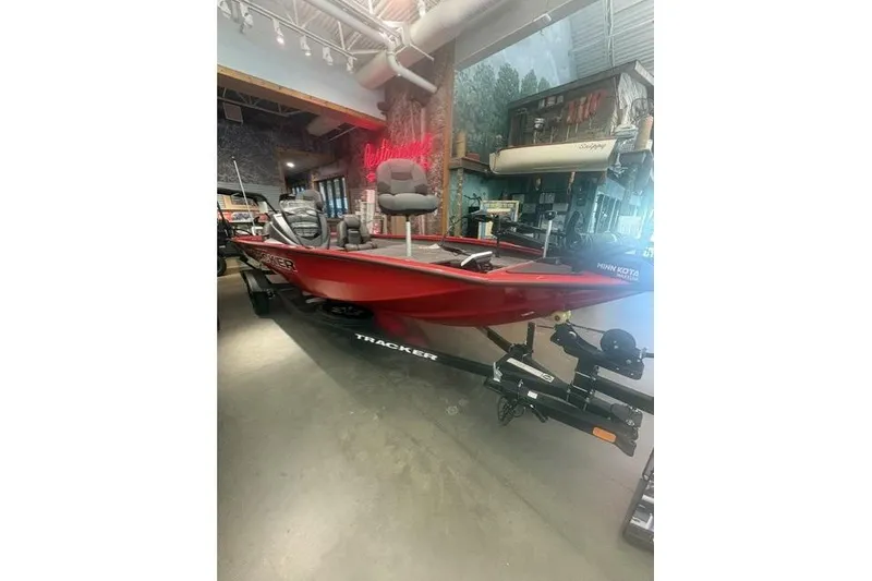 The Image of 2026 Tracker Pro Team 190 boat in showroom, red exterior, equipped with Minn Kota trolling motor. - 0