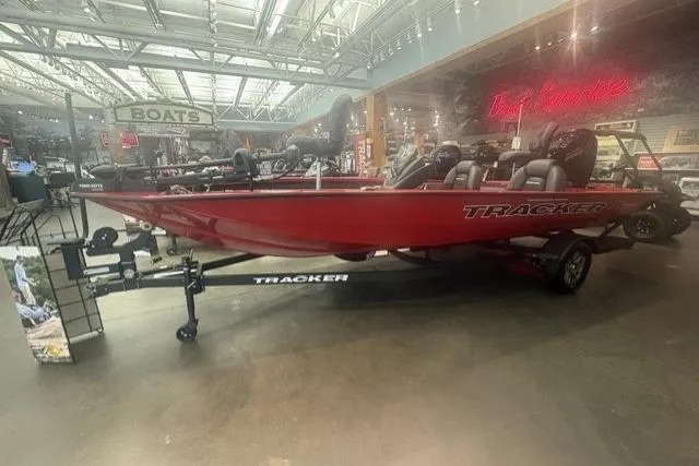 Slide: The Image of 2026 Tracker Pro Team 190 boat in showroom, red exterior, on trailer. - 3