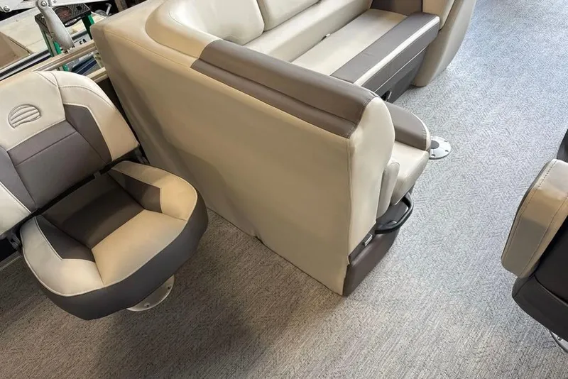 Slide: The Image of 2026 Sun Tracker Fishin' Barge 20 DLX interior seating, featuring plush, two-tone upholstery. - 11