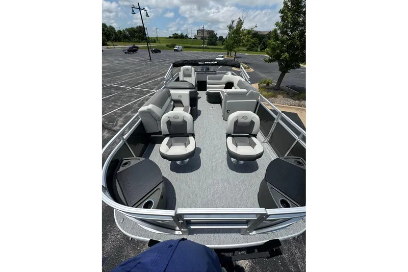Slide: The Image of 2026 Sun Tracker Fishin' Barge 20 DLX pontoon boat with spacious seating in a parking lot. - 14