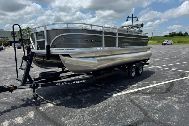 Slide: The Image of 2026 Sun Tracker Fishin' Barge 20 DLX pontoon boat on trailer in parking lot. - 3