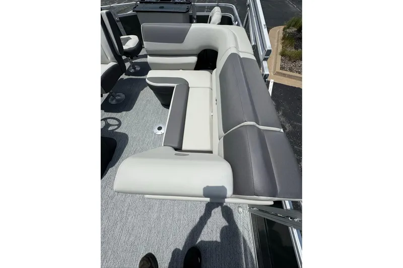 Slide: The Image of 2026 Sun Tracker Fishin' Barge 20 DLX interior seating, featuring gray and white upholstery. - 5