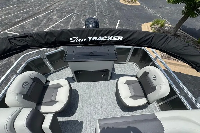Slide: The Image of 2026 Sun Tracker Fishin' Barge 20 DLX interior with seating and console. - 7