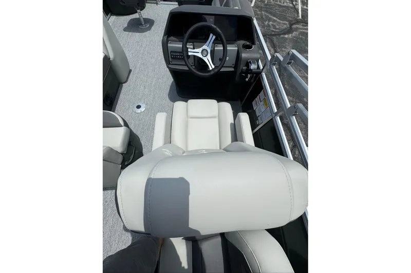 Slide: The Image of 2026 Sun Tracker Fishin' Barge 20 DLX interior with steering console and seating. - 8