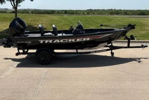The Image of 2026 Tracker Super Guide V-16 SC boat on trailer, parked outdoors. - 42