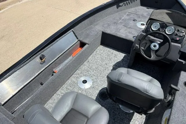 Slide: The Image of 2026 Tracker Super Guide V-16 SC boat interior with steering console and seating. - 51