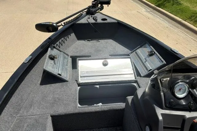 Slide: The Image of 2026 Tracker Super Guide V-16 SC boat interior with open storage compartments. - 49