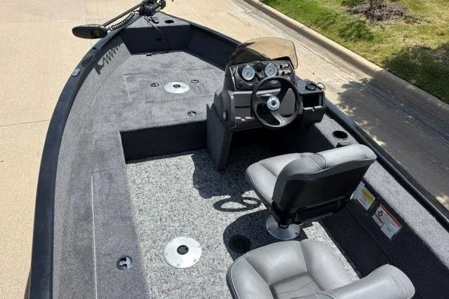 Slide: The Image of 2026 Tracker Super Guide V-16 SC fishing boat interior with steering console and seating. - 50