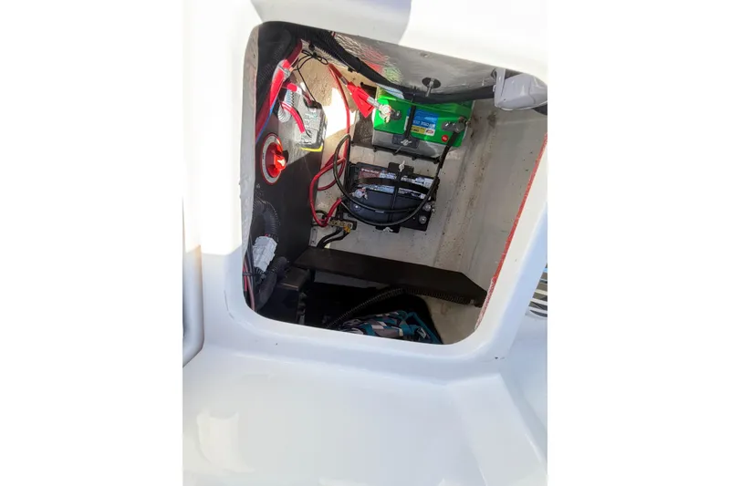 Slide: The Image of 2022 Regal 22 FasDeck boat battery compartment with wiring and components. - 7