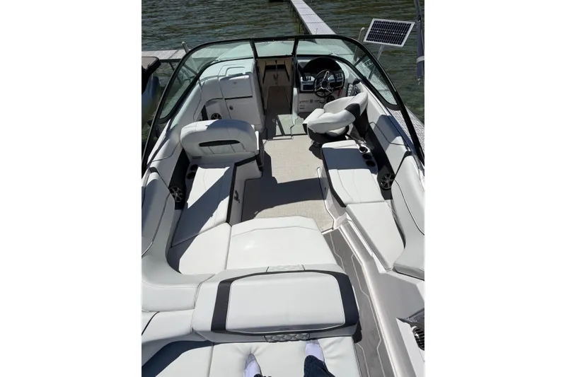 Slide: The Image of 2022 Regal 22 FasDeck boat interior with sleek seating and modern dashboard. - 9