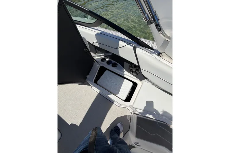 Slide: The Image of 2022 Regal 22 FasDeck boat interior with storage compartment and cup holders. - 6
