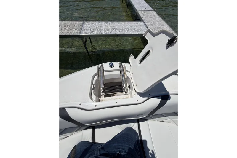 Slide: The Image of 2022 Regal 22 FasDeck boat with open storage compartment near dock. - 5