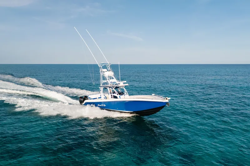 Slide: The Image of 2022 Nor-Tech 392 Super Fish boat cruising on open ocean waters. - 2