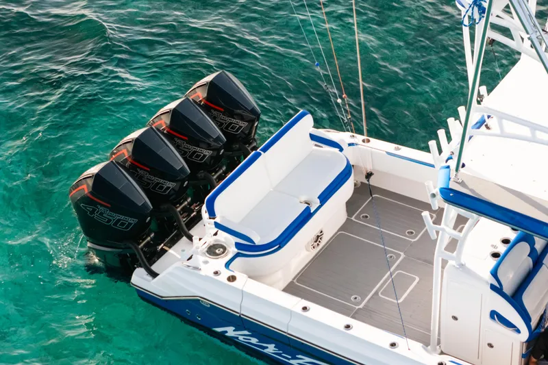 Slide: The Image of 2022 Nor-Tech 392 Super Fish boat with four powerful outboard engines on turquoise water. - 8