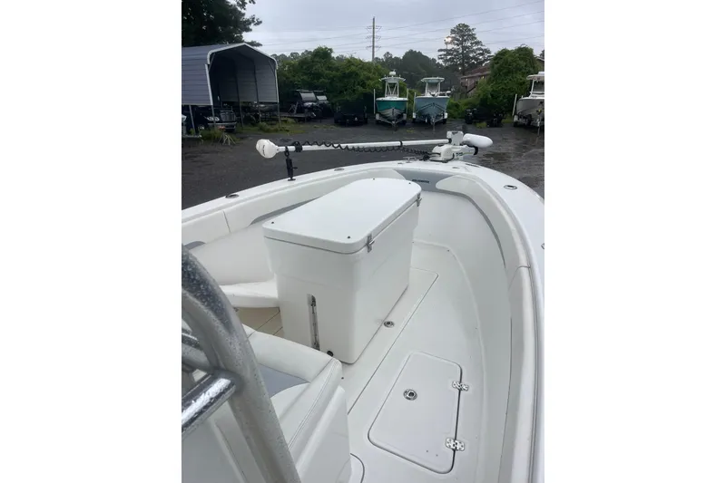 Slide: The Image of 2022 Bluewater 2550 CC boat interior with storage compartment, parked outdoors. - 11