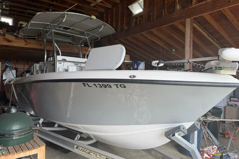 Slide: The Image of 2022 Bluewater 2550 CC boat in garage, on trailer, with registration FL 1399 TG. - 4