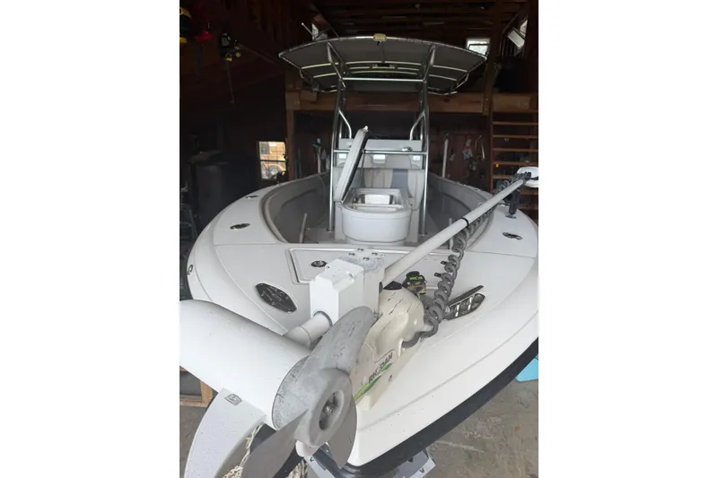 Slide: The Image of 2022 Bluewater 2550 CC boat in storage, featuring a trolling motor and spacious deck. - 5