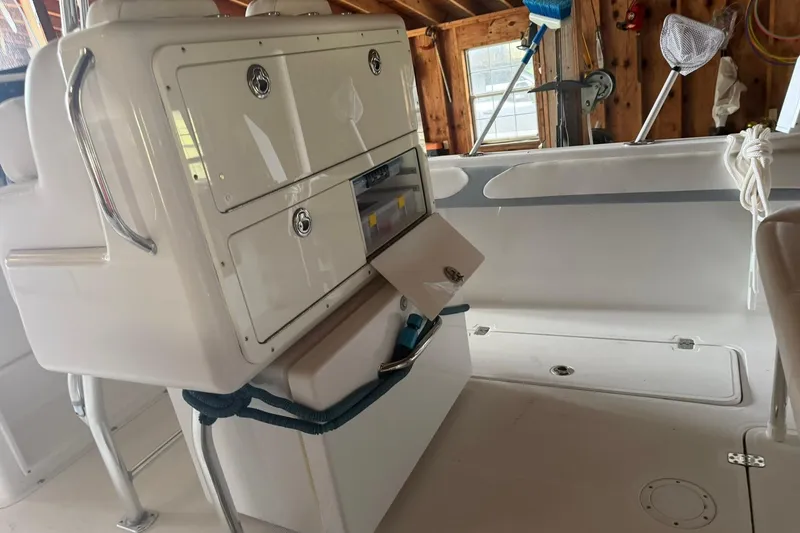 Slide: The Image of 2022 Bluewater 2550 CC boat interior with storage compartments open. - 7