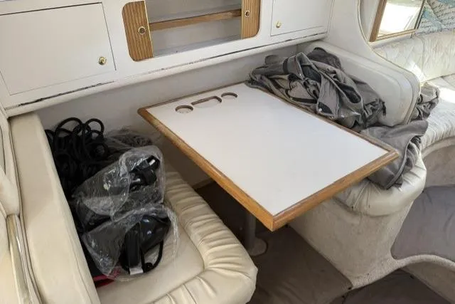 Slide: The Image of 1999 Sea Ray 290 Sundancer cabin interior with table and seating area. - 15