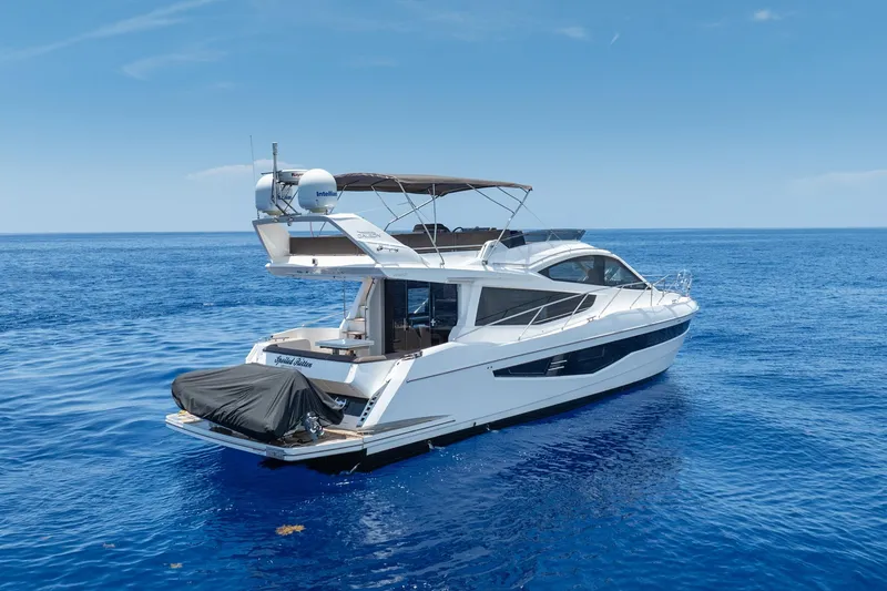 Slide: The Image of 2017 Galeon 550 Fly yacht cruising on open blue sea under clear sky. - 8