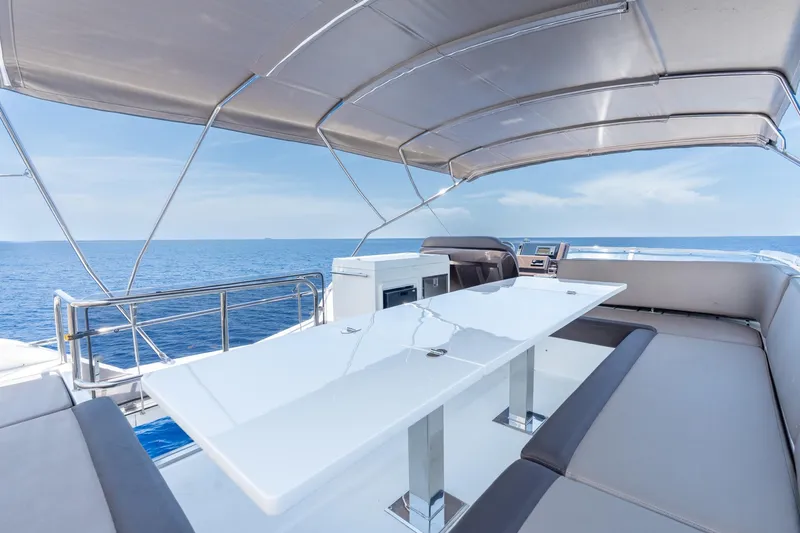 Slide: The Image of Flybridge of 2017 Galeon 550 Fly yacht with ocean view and seating area. - 25