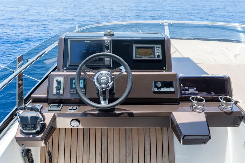 Slide: The Image of Helm of 2017 Galeon 550 Fly yacht with modern controls and ocean view. - 24