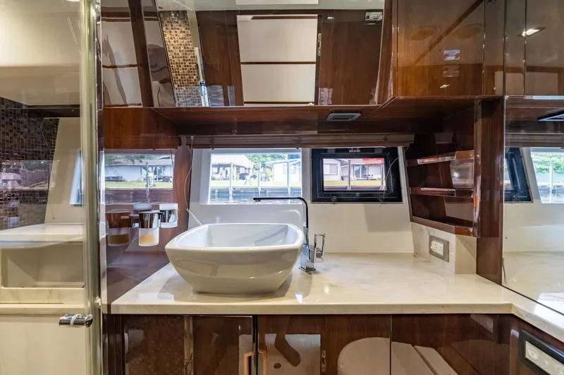 Slide: The Image of Luxurious bathroom interior of 2017 Galeon 550 Fly yacht with modern sink and wood finishes. - 51