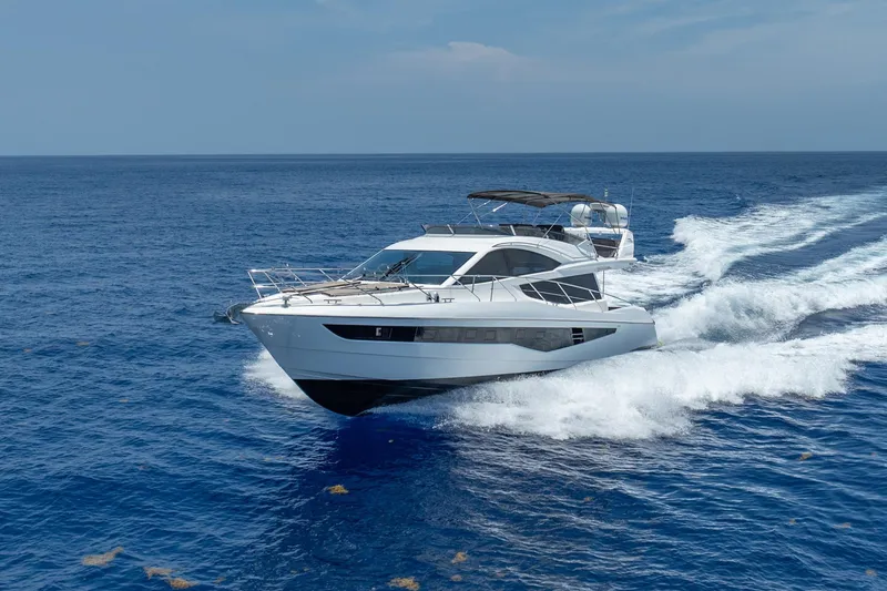 Slide: The Image of 2017 Galeon 550 Fly yacht cruising on open blue sea. - 6